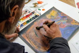 Rachel Thompson/News-Register##Jason Catron works on a watercolor painting during the art hour at McMinnville’s First Presbyterian Church. He said he doesn’t plan his art projects; his hands take over and create something. Rachel Thompson/News-Register##Jason Catron works on a watercolor painting during the art hour at McMinnville’s First Presbyterian Church. He said he doesn’t plan his art projects; his hands take over and create something.