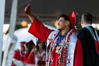Rachel Thompson/News-Register##Luis Mendoza proudly displays his brand-new McMinnville High School diploma, which was just handed to him as he walked across the stage Friday night. He was among about 537 graduates honored during the commencement event. Rachel Thompson/News-Register##Luis Mendoza proudly displays his brand-new McMinnville High School diploma, which was just handed to him as he walked across the stage Friday night. He was among about 537 graduates honored during the commencement event.