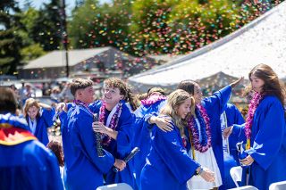 Rachel Thompson/News-Register##From left, Mason Rosenast, Tyler Petrasek, Kyla Jones, Mya Haarsma and Saralynn Grove celebrate with hugs and smiles as confetti fills the background following Amity High School’s graduation Saturday. Rachel Thompson/News-Register##From left, Mason Rosenast, Tyler Petrasek, Kyla Jones, Mya Haarsma and Saralynn Grove celebrate with hugs and smiles as confetti fills the background following Amity High School’s graduation Saturday.