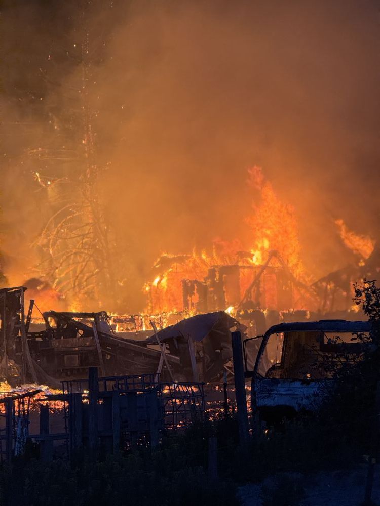 Rusty Rae/News-Register##It quickly spread from burning pallets to the adjacent house, sending black smoke and flames high into the sky.