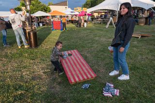 Rusty Rae/News-Register##Oregon Brews & BBQ brought family fun to the Yamhill County Fairgrounds last weekend. The event included fare from a number of barbecue eateries and local brewers, as well as music and activities for all ages. Gunner Sharp and Margo Corres of Hillsboro checked out the games area while the music played. A portion of the annual event’s proceeds go to the American Legion and Wounded Warrior Project.