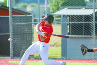 Taylor Carnahan swings at a pitch during Mac s 13-1 summer league victory over Newberg.
Rusty Rae/News-Register