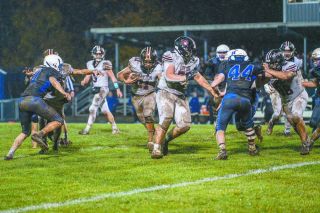 Kolby Wofford (No. 78) blocks for his running back Stephen Macias (No.11) as he dashes to the right side of the line of scrimmage in Dayton’s 16-0 win on the road at Amity. 
Rachel Thompson/News-Register file photo