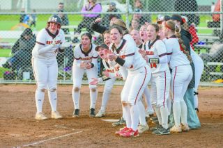 Kaylee Dinger (center) surrounds home plate with her teammates after Rylan Carton hit a home run in the Grizzlies’ 4-3 home win over Sunset on April 1. The Mac girls made a habit of mobbing their own girls at the plate after hitting balls over the wall. Later in the season a red rubber chicken made an appearance as a celebratory prop. Dinger credited her teammates for a lot of her success, saying, “The reason I’ve been doing well has been that I’ve been playing loose and been having fun with my teammates.” 
Rusty Rae
News-Register file photo