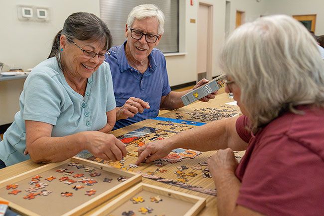 Rachel Thompson/News-Register##Patti Dalton, Terry Hainsworth and Karen Ostrand—competing as “The Puzzle Masters”—share a laugh while assembling a 500-piece jigsaw during Tuesday’s Puzzle Palooza at the McMinnville Senior Center. “They’re trying hard to get more adults involved,” said Ostrand, chair of the Friends of the Senior Center, which sponsored the event. “A lot of people think Summer Fun is just for kids, but this was open to all ages, and it was a lot of fun.” The event was part of McMinnville’s Summer Fun series, a collaboration between Parks and Recreation, the Public Library and other community partners. Rachel Thompson/News-Register##Patti Dalton, Terry Hainsworth and Karen Ostrand—competing as “The Puzzle Masters”—share a laugh while assembling a 500-piece jigsaw during Tuesday’s Puzzle Palooza at the McMinnville Senior Center. “They’re trying hard to get more adults involved,” said Ostrand, chair of the Friends of the Senior Center, which sponsored the event. “A lot of people think Summer Fun is just for kids, but this was open to all ages, and it was a lot of fun.” The event was part of McMinnville’s Summer Fun series, a collaboration between Parks and Recreation, the Public Library and other community partners.
