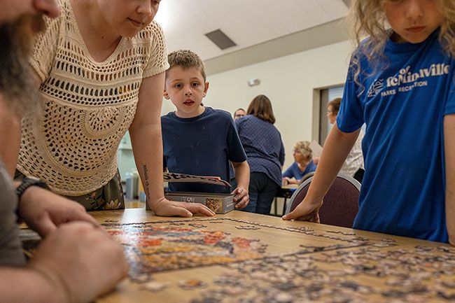 Rachel Thompson/News-Register##hris and Reyna Starr work alongside their children, Emerson (middle), 8, and Haven, 10, during Tuesday’s event. Competing as “The Starrs,” the family tackled the 500-piece challenge together as one of eight registered teams. Rachel Thompson/News-Register##hris and Reyna Starr work alongside their children, Emerson (middle), 8, and Haven, 10, during Tuesday’s event. Competing as “The Starrs,” the family tackled the 500-piece challenge together as one of eight registered teams.