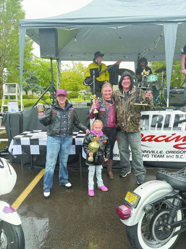 From left to right, Katy Hall, Bailey, Nicole Evans and Henry Robinson hold up their trophies from the bike show held during Bikestock. Robinson won first place, Bailey took home second, Evans secured third place and Hall was awarded the Kids Choice Award. Hall is also one of 12 who compete on the drag racing team. The group competes at Woodburn Drag Strip in Marion County. 
Photo courtesy of Nicole Evans