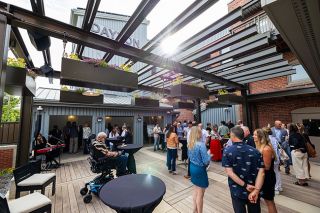 Rachel Thompson/News-Register##Dayton residents and people who worked on the inn project gather on the patio in back to celebrate its grand opening. Escape Lodging will operate the 12-room boutique hotel, which was constructed in a vintage building that once held a bank. Retail businesses are planned for the ground floor facing Ferry Street. Rachel Thompson/News-Register##Dayton residents and people who worked on the inn project gather on the patio in back to celebrate its grand opening. Escape Lodging will operate the 12-room boutique hotel, which was constructed in a vintage building that once held a bank. Retail businesses are planned for the ground floor facing Ferry Street.