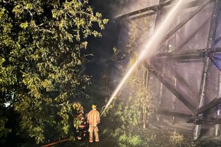 Tualatin Valley Fire & Rescue photos##Above: Firefighters continue to douse the trestle of an inactive rail line in Newberg Sunday morning. Below: A large section of the trestle is engulfed as crews arrive at the scene. Tualatin Valley Fire & Rescue photos##Above: Firefighters continue to douse the trestle of an inactive rail line in Newberg Sunday morning. Below: A large section of the trestle is engulfed as crews arrive at the scene.