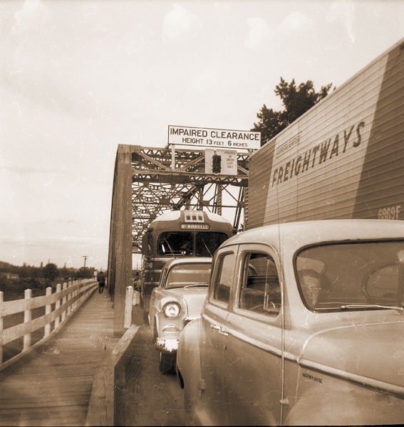 (June 28, 1955) Traffic was held up on the Dayton Bridge for nearly an hour Friday when a northbound truck, whose driver apparently didn’t believe the impaired clearance warning, was unable to squeeze under the low overhead structure. The bus in the picture, unable to pass the truck on the narrow bridge, further added to the congestion. (June 28, 1955) Traffic was held up on the Dayton Bridge for nearly an hour Friday when a northbound truck, whose driver apparently didn’t believe the impaired clearance warning, was unable to squeeze under the low overhead structure. The bus in the picture, unable to pass the truck on the narrow bridge, further added to the congestion.
