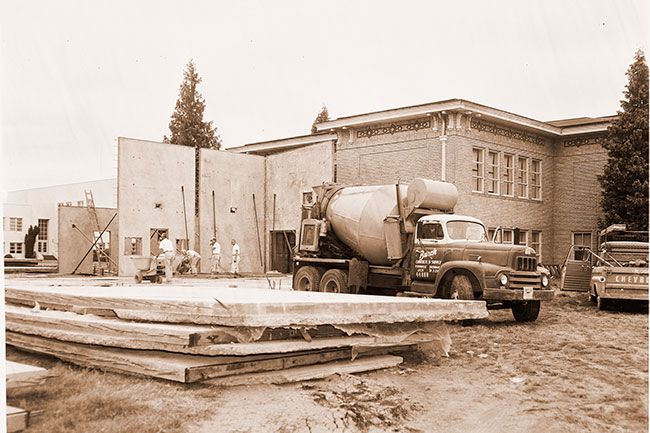 (July 1, 1960) Workmen for Lantz Construction Company of Salem Thursday started pre-pouring cement floors for the Adams School multi-purpose room. First floors were ruined when they pulled loose from foundations as workmen raised the walls which had been poured on top of the floors with a bond-breaking compound between the two. (July 1, 1960) Workmen for Lantz Construction Company of Salem Thursday started pre-pouring cement floors for the Adams School multi-purpose room. First floors were ruined when they pulled loose from foundations as workmen raised the walls which had been poured on top of the floors with a bond-breaking compound between the two.