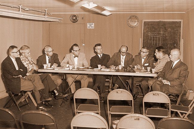 (July 1, 1960) A touring group of Springfield Chamber of Commerce members stopped at the McMinnville Chamber office Thursday morning to learn more about McMinnville Industrial Promotions, Inc., which has brought several new industries to McMinnville. Shown, from right to left, are; Gale Vinton, MIP vice-president; Phil Bladine, MIP board member; Cliff Elliott, MIP secretary; Bob Smith, manager of the Springfield Chamber; Willard L. Cushing, representing McMinnville Chamber; Merrill Hagan, president of the McMinnville Chamber; Stan Torvik of the Springfield Chamber; Daren Engel, chairman of the Springfield Chamber subcommittee on industrial parks; and Jack Criswell of the Springfield Chamber. Elliott outlined how and why McMinnville formed a corporation to stimulate industrial growth in the city. The visiting chamber members visited Rex Mobile Homes before leaving for Forest Grove and Hillsboro. (July 1, 1960) A touring group of Springfield Chamber of Commerce members stopped at the McMinnville Chamber office Thursday morning to learn more about McMinnville Industrial Promotions, Inc., which has brought several new industries to McMinnville. Shown, from right to left, are; Gale Vinton, MIP vice-president; Phil Bladine, MIP board member; Cliff Elliott, MIP secretary; Bob Smith, manager of the Springfield Chamber; Willard L. Cushing, representing McMinnville Chamber; Merrill Hagan, president of the McMinnville Chamber; Stan Torvik of the Springfield Chamber; Daren Engel, chairman of the Springfield Chamber subcommittee on industrial parks; and Jack Criswell of the Springfield Chamber. Elliott outlined how and why McMinnville formed a corporation to stimulate industrial growth in the city. The visiting chamber members visited Rex Mobile Homes before leaving for Forest Grove and Hillsboro.