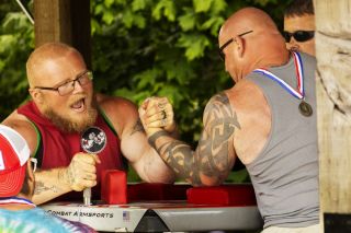 Nicolas Mode (left) screams and brings down the meaty arm of Bryan Fry (right) during the open/pro 243+ division arm wrestling competition. Mode went undefeated in his rounds, beating most of his opponents in a split second. “Arm wrestling is a passion for me,” Mode said. “It’s like a brotherhood. We all get along. We all love it. We’re all here for the same purpose, to have fun.”
Nathan Ecker/News-Register