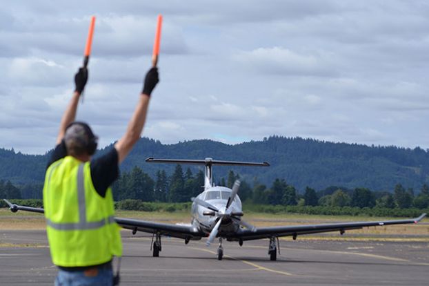 Rachel Thompson/News-Register##Potcake Aviation’s Wes Cryderman guides a PC-12 plane to the runway of McMinnville Municipal Airport. Projects in the airport master plan address an increase in private jet traffic. The city wants to establish a business plan to accommodate the growth.