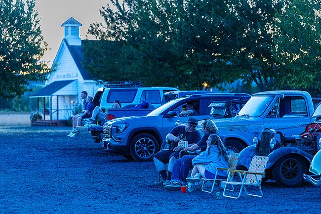 Rachel Thompson/News-Register##The parking lot turns into an open-air theater Saturday as moviegoers enjoy “Footloose” (1984) during the Yamhill County Historical Society’s Summer Nights event. The car show and movie night drew families, friends and classic car lovers for an old-fashioned summer evening. Rachel Thompson/News-Register##The parking lot turns into an open-air theater Saturday as moviegoers enjoy “Footloose” (1984) during the Yamhill County Historical Society’s Summer Nights event. The car show and movie night drew families, friends and classic car lovers for an old-fashioned summer evening.