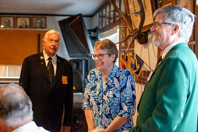 Rachel Thompson/News-Register##Patty Fries, center, a volunteer with the Saturday Morning Breakfast program, accepts a $200 check for the program from the Benevolent and Protective Order of Elks, McMinnville Lodge 1283. Vern Popowski, esquire with the Elks, left, and Joe Hicke, exalted ruler, presented the fund to help the nonprofit organization continue its mission of feeding people in need. Saturday Morning Breakfast feeds 250 to 400 people a week who are homeless, seniors or members of families just getting by despite working multiple jobs. The program is on hiatus this month as board members determine how to raise funds from the community and deal with federal cuts that have reduced food availability.