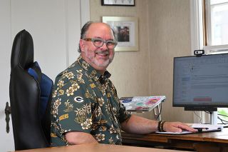 Rusty Rae/News-Register##Departing City Manager Jeff Towery wraps up some work at his desk at McMinnville City Hall. Towery is frequently sporting Green Bay Packers gear, a team he has been a fan of since they won the Super Bowl in 1967. Towery’s father banned rooting for “big city” teams like his native state’s Chicago Bears, so Towery chose Green Bay. “I picked a winning team, and then the Packers went 28 years without being in the playoffs and I stuck with them,” he said. “So I don’t feel like a bandwagon fan because there was a lot of lean time between the time Bart Starr left and the time Brett Favre came.”