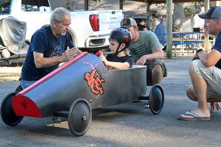 Rusty Rae/News-Register##Oren Cates listens to his grandfather, Mark Pendergrass, give a pointer about driving his car in the Derby Days event Saturday at Beulah City Park. Partially hidden in the center is Gus Womack and at right is Chris Alexander. Oren made numerous runs in the practice session Tuesday evening, along with other local youths getting ready for the competition Saturday. Rusty Rae/News-Register##Oren Cates listens to his grandfather, Mark Pendergrass, give a pointer about driving his car in the Derby Days event Saturday at Beulah City Park. Partially hidden in the center is Gus Womack and at right is Chris Alexander. Oren made numerous runs in the practice session Tuesday evening, along with other local youths getting ready for the competition Saturday.