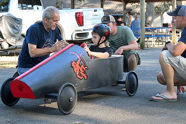 Rusty Rae/News-Register##Oren Cates listens to his grandfather, Mark Pendergrass, give a pointer about driving his car in the Derby Days event Saturday at Beulah City Park. Partially hidden in the center is Gus Womack and at right is Chris Alexander. Oren made numerous runs in the practice session Tuesday evening, along with other local youths getting ready for the competition Saturday. Rusty Rae/News-Register##Oren Cates listens to his grandfather, Mark Pendergrass, give a pointer about driving his car in the Derby Days event Saturday at Beulah City Park. Partially hidden in the center is Gus Womack and at right is Chris Alexander. Oren made numerous runs in the practice session Tuesday evening, along with other local youths getting ready for the competition Saturday.