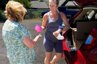 Starla Pointer/News-Register##Lauren Randolph, right, of Syringa Boutique shows newly printed pink cups to Jerre Harris of Patton Valley Wines. Randolph custom-etched the cups for the Drink Pink breast cancer fundraiser, which Patton Valley is sponsoring July 26 at Stoller Family Estates, along with numerous other wineries.