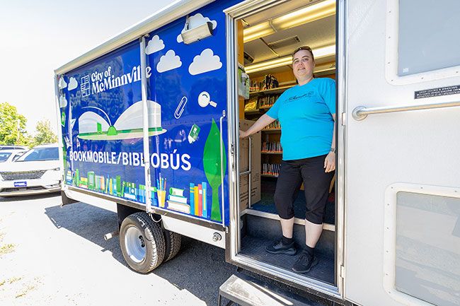 Rachel Thompson/News-Register##Library specialist Kirsten Dennis stands ready Wednesday to welcome kids and their families to the McMinnville Public Library bookmobile at Joel Perkins Park in Lafayette. It’s a weekly stop through Aug. 21. McMinnville locations include Redwood Commons on Mondays, Villa Del Sol Apartments on Tuesdays and Tice Park Apartments on Thursdays, all from 10:30 a.m. to noon Rachel Thompson/News-Register##Library specialist Kirsten Dennis stands ready Wednesday to welcome kids and their families to the McMinnville Public Library bookmobile at Joel Perkins Park in Lafayette. It’s a weekly stop through Aug. 21. McMinnville locations include Redwood Commons on Mondays, Villa Del Sol Apartments on Tuesdays and Tice Park Apartments on Thursdays, all from 10:30 a.m. to noon