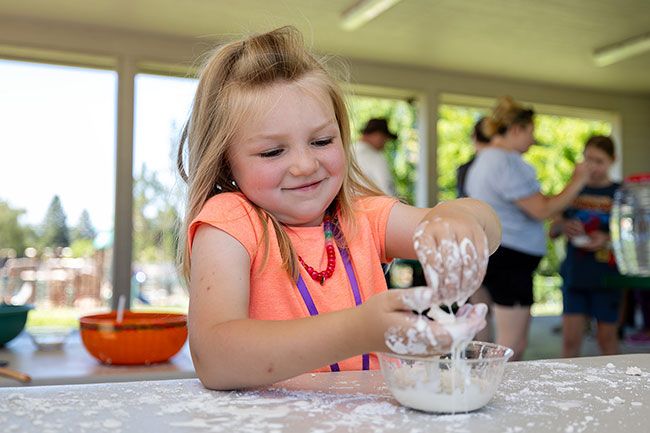 Rachel Thompson/News-Register## Lucille Drebin, 4, squeezes oobleck during a science activity. Rachel Thompson/News-Register## Lucille Drebin, 4, squeezes oobleck during a science activity.