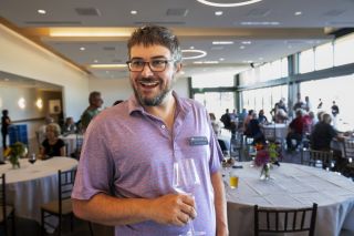 Rusty Rae/News-Register##At a customer appreciation event, Headwater Investment Consulting co-owner Kevin Chambers discusses working with private customers, businesses and nonprofits. His father, Linfield University professor Scott Chambers, started the company.