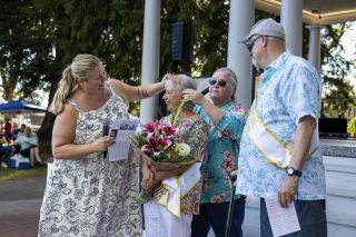 Rachel Thompson/News-Register##Elva Martinez, center, is crowned queen of the 2025 Dayton Old Timers Weekend by outgoing queen Carol Jensen during Saturday’s ceremony in Courthouse Square Park. Emcee Beth Wytowski, left, and King Wayne Herring, right, share in the moment.
