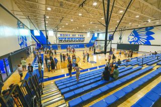 Members of the community mingle inside of the new Amity High School gymnasium after the ribbon cutting ceremony on Wednesday, July 30. Boys head basketball coach Devin McShane said of the gym, “I don’t know of any other 3A school that has a place as nice or a more complete facility.” Around 200 people, including coaches and school staff, were in attendance to grab their first glance of the newborn facility.
Rachel Thompson/News-Register