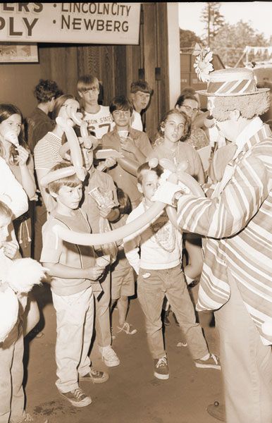 (Aug. 15, 1970) ##One of the well-received attractions at the Yamhill County Fair this year is balloon-making by Tacki the Clown, shown displaying his skill for some youngsters Wednesday. Tacki will be on the grounds Saturday distributing balloons and performing with a trained poodle. (Aug. 15, 1970) ##One of the well-received attractions at the Yamhill County Fair this year is balloon-making by Tacki the Clown, shown displaying his skill for some youngsters Wednesday. Tacki will be on the grounds Saturday distributing balloons and performing with a trained poodle.