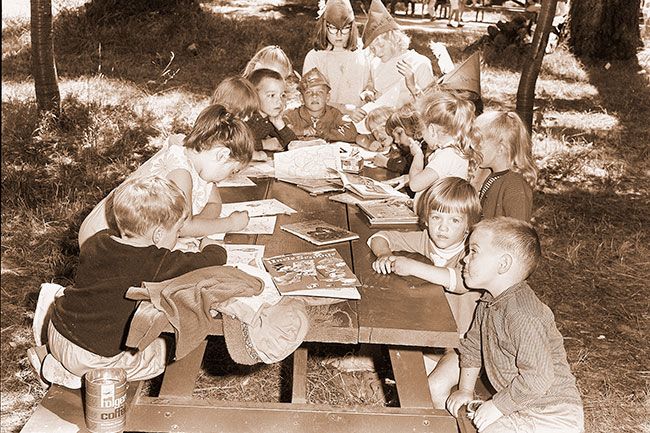 (July 28, 1965) ##Members of the Pixie Unit at the Girl Scout sponsored Day Camp held last week at Wortman Park listen to a reading of “Cinderella.” The unit was composed of children of the Day Camp leaders. Reading the story, but not shown in the picture, was Donna Brentano. Helpers were Sally Spencer and Joni Palmer. (July 28, 1965) ##Members of the Pixie Unit at the Girl Scout sponsored Day Camp held last week at Wortman Park listen to a reading of “Cinderella.” The unit was composed of children of the Day Camp leaders. Reading the story, but not shown in the picture, was Donna Brentano. Helpers were Sally Spencer and Joni Palmer.