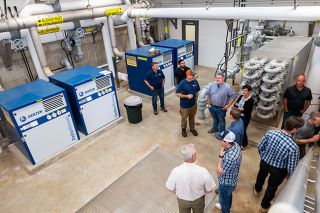 Rusty Rae/News-Register##City of McMinnville leadership and project representatives tour the new blower room Monday at the wastewater reclamation facility. Wastewater Services Manager Leland Koester says the blowers are used to aerate digester tanks. That keeps the thermophilic microbes “happy and active” to assist with the digestion process that produces Class A biosolids. Rusty Rae/News-Register##City of McMinnville leadership and project representatives tour the new blower room Monday at the wastewater reclamation facility. Wastewater Services Manager Leland Koester says the blowers are used to aerate digester tanks. That keeps the thermophilic microbes “happy and active” to assist with the digestion process that produces Class A biosolids.