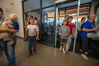 Rachel Thompson/News-Register##After the ribbon cutting, more than 200 community members pour through the doors of the new Amity Middle School, taking their first look at the light-filled space that will soon welcome grades six through eight. Rachel Thompson/News-Register