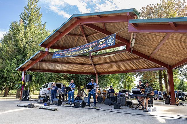Rachel Thompson/News-Register##Carlton police officers and community members team up as the Carlton Blues Band, performing &ldquo;Under the Boardwalk&rdquo; during National Night Out in Wennerberg Park. The band set the tone for an evening of food, games and family fun.