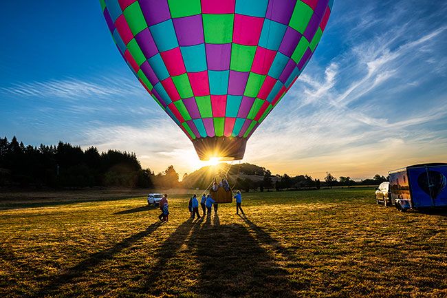 Rusty Rae/News-Register##Lift-off on the first ride of the morning in Heaven Bound Too to kick off the festivities at the Rock of Ages Fun Festival. 
Below: Aeronaut/Pilot Chris Whitfield, a 20-year veteran hot air balloon driver, casts a shadow in the morning light as he completes a preflight check of his balloon.