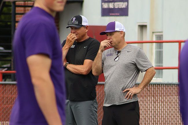 Nathan Ecker/News-Register##Coach Smith and running backs coach Greg McAnally have a discussion during day one of fall practices. Linfield enters the &lsquo;25 season without former offensive coordinator Brett Elliott, who took his first head coach job leading conference rival Lewis & Clark College.