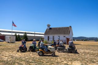 Rachel Thompson/News-Register##Square dancers practice their moves on a field near the vintage schoolhouse at the Yamhill County Historical Society’s Yamhill Valley Heritage Center. Lawn Tractor Square Dancing is a new activity at this weekend’s Harvest Fest, which features mid-19th century agricultural and community activities. Although no riding mowers existed back then, square dancing was a popular activity. Rachel Thompson/News-Register##Square dancers practice their moves on a field near the vintage schoolhouse at the Yamhill County Historical Society’s Yamhill Valley Heritage Center. Lawn Tractor Square Dancing is a new activity at this weekend’s Harvest Fest, which features mid-19th century agricultural and community activities. Although no riding mowers existed back then, square dancing was a popular activity.