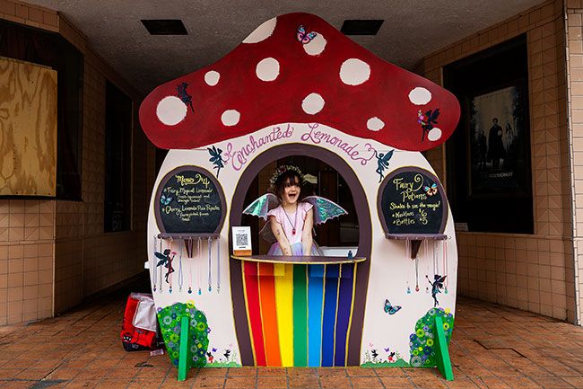Rachel Thompson/News-Register##Five-year-old Charlotte Knapp offers “Fairy Magical Lemonade,” “Cherry Limeade Pixie Popsicles” and bottled fairy potions from her mushroom-shaped stand outside the Mack Theater. She received a Lemonade Day award for Excellent Use of Whimsy. Rachel Thompson/News-Register##Five-year-old Charlotte Knapp offers “Fairy Magical Lemonade,” “Cherry Limeade Pixie Popsicles” and bottled fairy potions from her mushroom-shaped stand outside the Mack Theater. She received a Lemonade Day award for Excellent Use of Whimsy.
