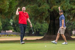 Brady Martin, left, and Julian Urena, right, celebrate a lengthy putt sunk by Urena during the MHS Hall of Fame golf tournament at Michelbook Country Club on Saturday, August 16.##Nathan Ecker/News-Register Brady Martin, left, and Julian Urena, right, celebrate a lengthy putt sunk by Urena during the MHS Hall of Fame golf tournament at Michelbook Country Club on Saturday, August 16.##Nathan Ecker/News-Register