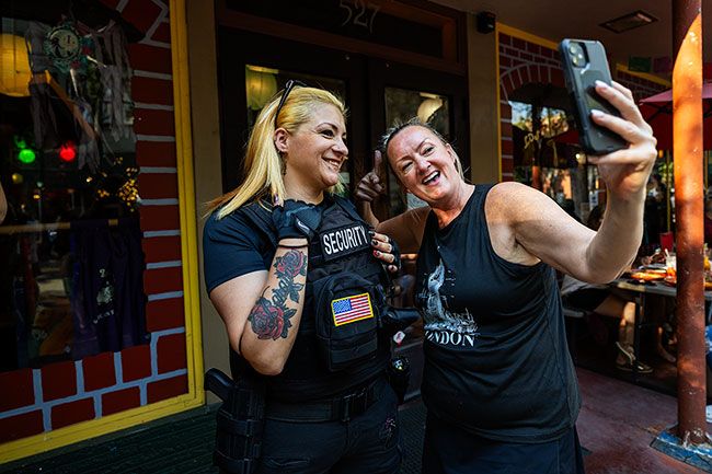 Rachel Thompson/News-Register##Crystal Marks of McMinnville stops for a selfie with Lucy Barajas of Newberg, part of the event’s security team, outside Los Molcajetes. Rachel Thompson/News-Register##Crystal Marks of McMinnville stops for a selfie with Lucy Barajas of Newberg, part of the event’s security team, outside Los Molcajetes.