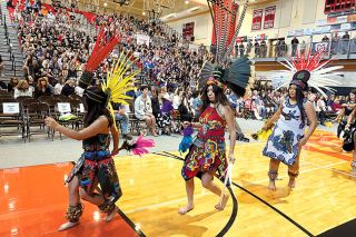 Starla Pointer/News-Register##Danza Azteca dancers perform for McMinnville School District staff members during an all-district welcome back program last week in the McMinnville High School gym. The district has more than 800 employees. Interim Superintendent Kourtney Ferrua urged them to work together this year to allow all students to reach their full potential. “Thank you all for all you do,” she said during the program.