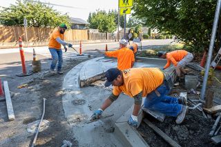 Rachel Thompson/News-Register##Led by Chris Szedlak, Concrete Solutions Inc. finishes a crosswalk ramp at the corner of Jackson Street and Bridge Street in Lafayette. Throughout August, sidewalks and crosswalks on Bridge Street were repaired and updated to be ADA compliant. Road repairs are scheduled to follow starting Sept. 15. Rachel Thompson/News-Register##Led by Chris Szedlak, Concrete Solutions Inc. finishes a crosswalk ramp at the corner of Jackson Street and Bridge Street in Lafayette. Throughout August, sidewalks and crosswalks on Bridge Street were repaired and updated to be ADA compliant. Road repairs are scheduled to follow starting Sept. 15.