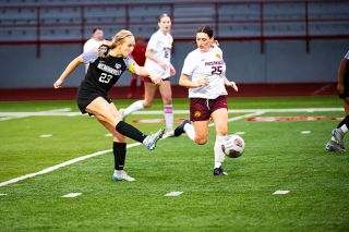 Junior midfielder Ailey Becker strikes the ball into the net for her first goal of McMinnville’s match against Milwaukie/Milwaukie Academy of the Arts on Thursday, Sept. 11 at Wortman Stadium. Becker scored two goals and assisted teammate Tessa Ravia on a number of her scores.##Rusty Rae/News-Register