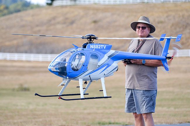 Rachel Thompson/News-Register##Dave Bottita of Las Vegas flies his scale model MD 530F helicopter Wednesday at the RC Helicopter Scale Masters event. A replica of a Tennessee Valley Authority aircraft, the model took nearly a year to build. Rachel Thompson/News-Register##Dave Bottita of Las Vegas flies his scale model MD 530F helicopter Wednesday at the RC Helicopter Scale Masters event. A replica of a Tennessee Valley Authority aircraft, the model took nearly a year to build.