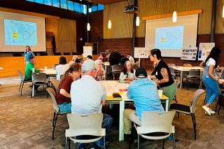 Scott Unger/News-Register##Members of the consulting team lead local residents through an exercise placing various amenities like housing and parks on a map of the Southwest Area. The consultants will incorporate the responses into several scenarios that will be presented later.