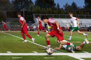 Senior forward Jose Farias breaks toward the goal after dribbling the ball away from a Lions defender in the first half of play between Mac and West Linn at Wortman Stadium on Sept. 16.##Nathan Ecker/News-Register