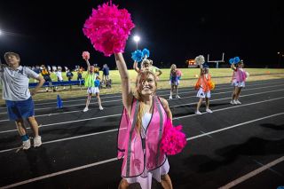 Sheridan cheer captain Lana Curl and her team lead the home crowd at the Sept. 5 Sheridan vs. Willamina football game. This season Sheridan and Willamina high schools have formed a co-op cheer team, allowing the Bulldogs to join Spartan Cheer. During West Valley match ups, the cheerleaders will support both teams, while wearing respective logos for each school.##Rachel Thompson/News-Register