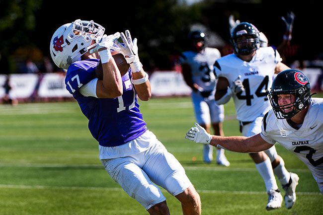 Caleb Woodcock secures a pass from Luke McNabb, who dropped the ball directly into Woodcock’s basketed arms as he approached the north endzone at Maxwell Field. The veteran duo were ecstatic to finally see dividends pay off after months of working out together.##Rusty Rae/News-Register