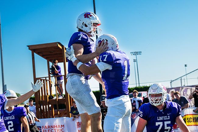 Luke McNabb and Caleb Woodcock celebrate in the endzone after McNabb s rushing touchdown.##Rusty Rae/News-Register