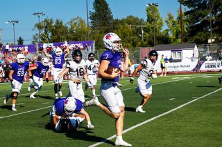 Luke McNabb runs for a touchdown to ice the Wildcats 28-13 victory over Chapman at Maxwell Field on Saturday, Sept. 20.##Rusty Rae/News-Register